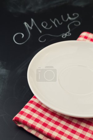 Empty plate on chalkboard with word menu