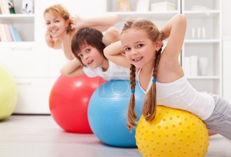 Kids exercising with their mother