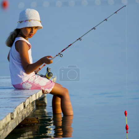 Fishing - lovely girl fishing on the pier