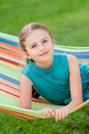 Summer, rest in the garden - lovely girl in colorful hammock