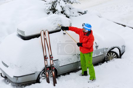 Ski, Winter, snow, car - skier man is shoveling the car of snow