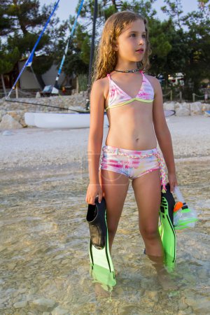 Summer joy, beach - young girl diver in the sea