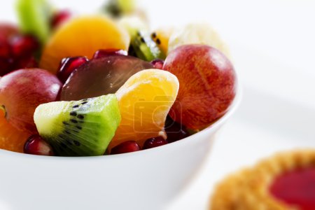 Diet, healthy fruit salad in the white bowl - healthy breakfast