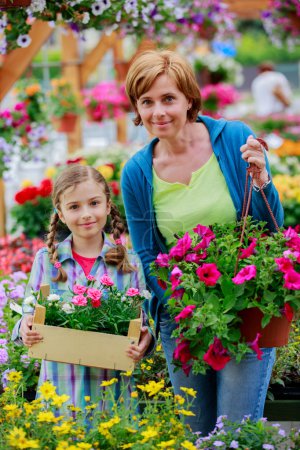Planting, garden flowers - family shopping plants and flowers in garden center