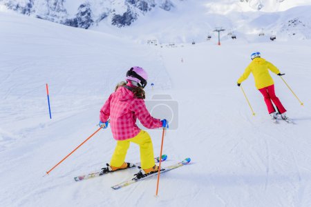 Ski, skiers on ski run - female skiers skiing downhill