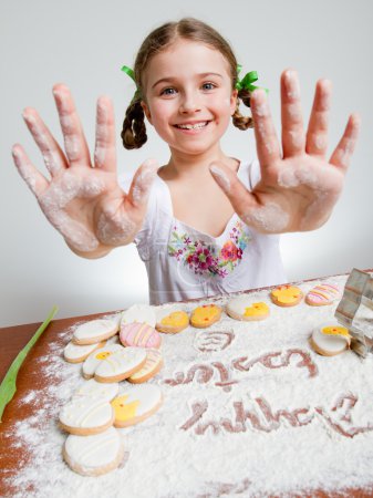 Happy Easter - lovely girl making easter cookies
