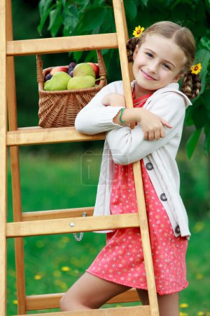 Fruits orchard, garden - lovely girl with picked ripe pears and plums