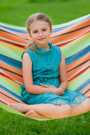 Summer, rest in the garden - lovely girl in colorful hammock