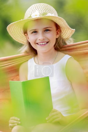Summer joy, hammock - girl with a book resting on a hammock