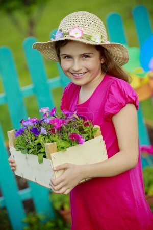 Gardening, planting - lovely girl  working in flowers garden