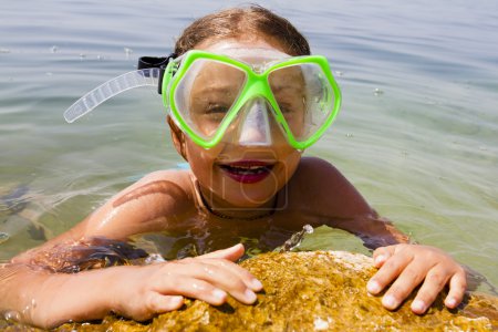 Summer joy, beach - young girl diver in the sea