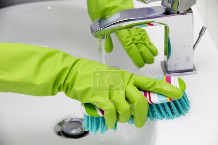 Cleaning - cleaning bathroom sink with spray detergent - housework