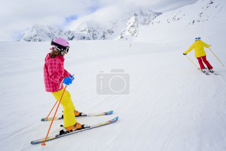 Skiing, skiers on ski run - child skiing downhill, ski lesson