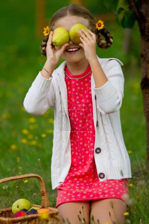 Fruits orchard, garden - lovely girl with picked ripe pears