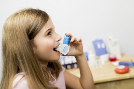 Allergy -  cute girl using  inhaler