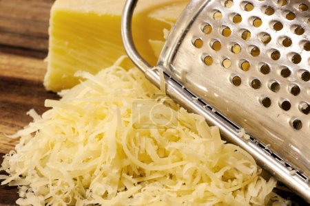 Grated Cheese and Grater on Board
