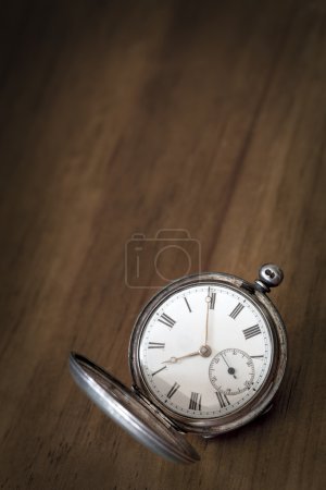 Vintage Pocket Watch over Grunge Timber