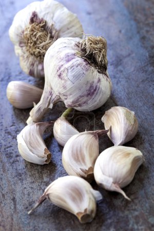 Garlic Bulbs and Cloves on Rustic Timber
