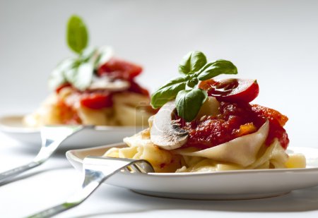 Italian pasta with tomato sauce and mushrooms