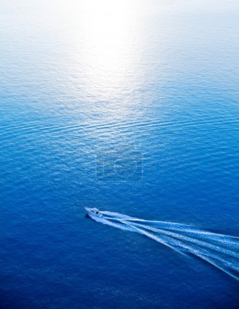 Boat cruising blue Mediterranean sea aerial view