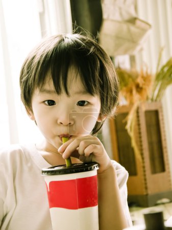 asian boy drinking ice green tea