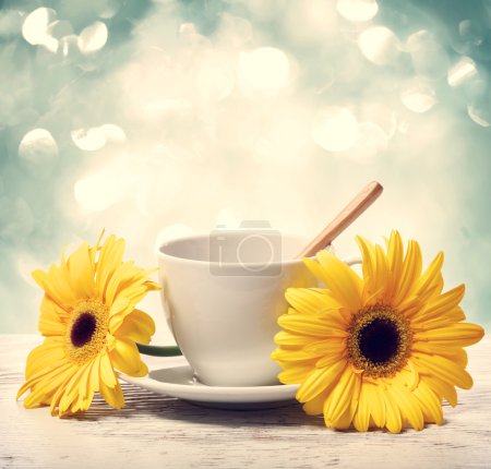 Coffee cup with yellow gerberas 