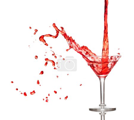 Red cocktail splashing from glass