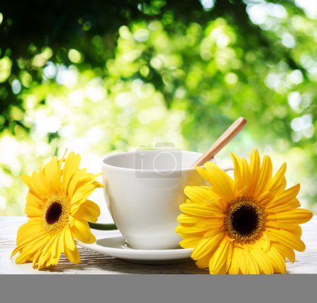 Coffee cup with yellow gerberas