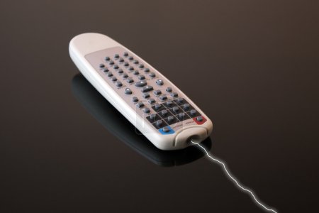 Remote control for dvd player over dark background