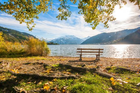 Beautiful autumn scene with park bench and mountain lake in the Alps, Zell am See, Salzburger Land, Austria