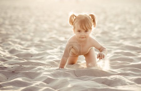 Abdorable baby girl on the beach