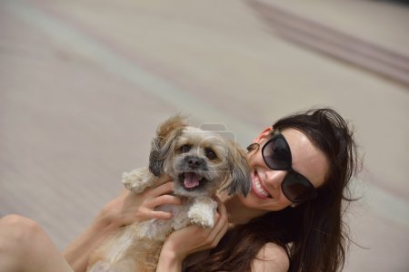 Young woman with puppy have fun