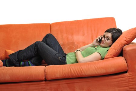 happy young woman relax on orange sofa