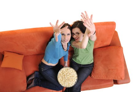 Friends eating popcorn and watching tv