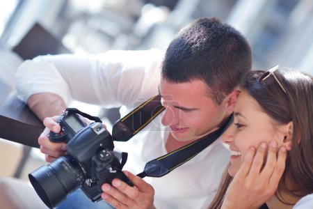 Couple looking photos on camera