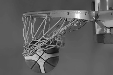 Basketball ball and net on black background
