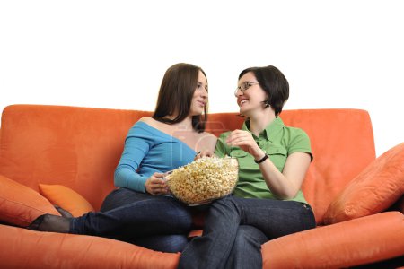 Friends eating popcorn and watching tv