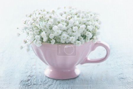 Pink cup with white flowers