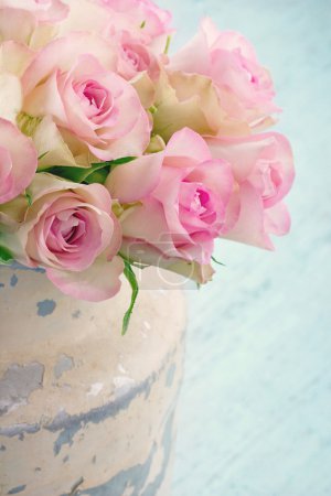 Roses in a shabby chic metal bucket