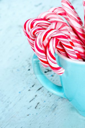 Candy canes in a light blue cup