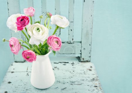 White and pink flowers on light blue chair