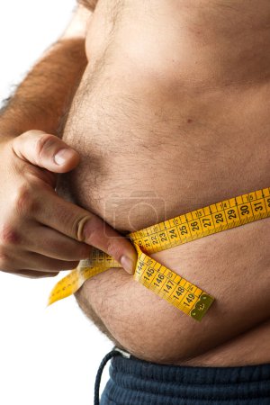 A man measuring his belly fat