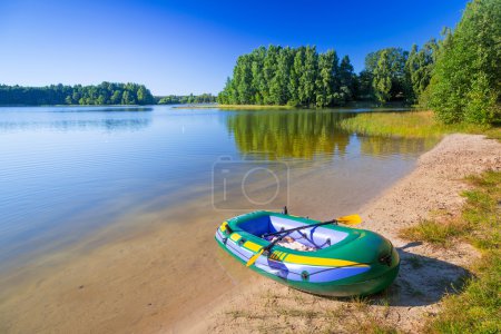 Inflatable dinghy at the summer lake