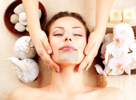 Spa Massage. Young Woman Getting Facial Massage