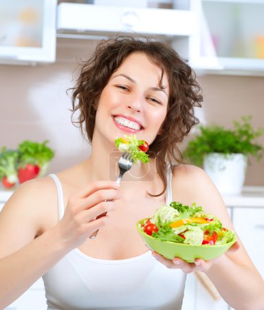 Diet. Beautiful Young Woman Eating Vegetable Salad