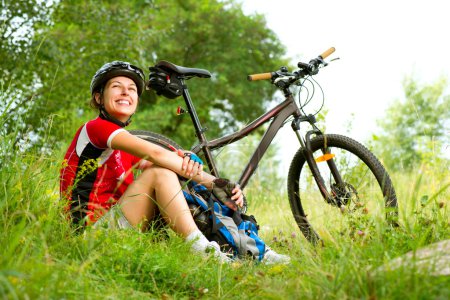 Happy Young Woman riding bicycle outside. Healthy Lifestyle