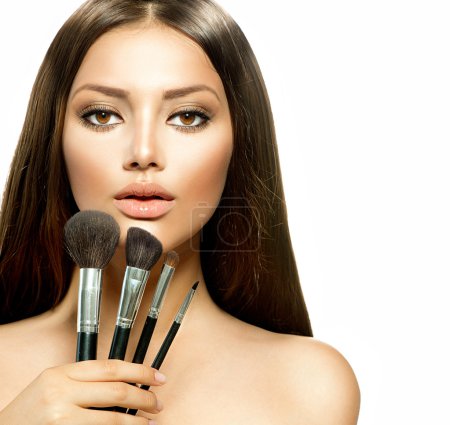 Beauty Girl with Makeup Brushes. Make-up for Brunette Woman