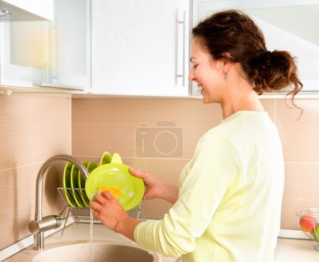 Woman Washing Dishes. Kitchen
