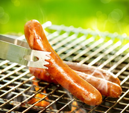 Grilled Sausage on the flaming Grill. BBQ. Bearbeque outdoors