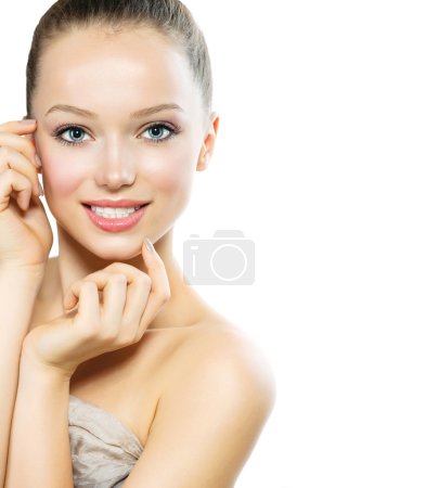 Beautiful Young Woman with Fresh Clean Skin touching her Face